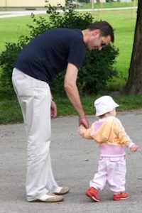 Kid Walking with Her Parent